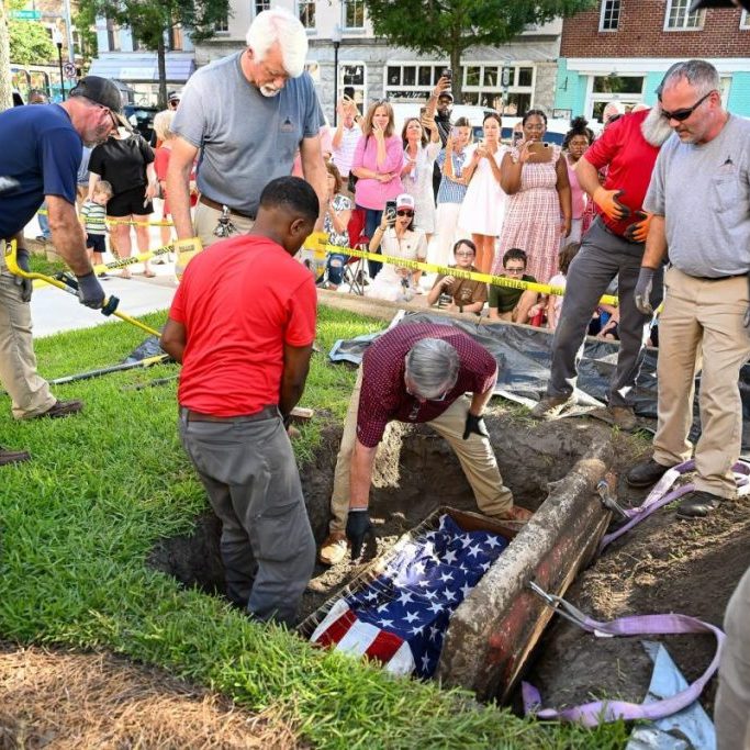 val - time capsule Photo...The diggers see Old Glory as the first item stored in the capsule.